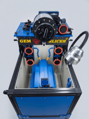 Open cutting chamber of a Gem Slicer Standard, showing the wire guides, the coolant nozzle and the stone carriage on its rail